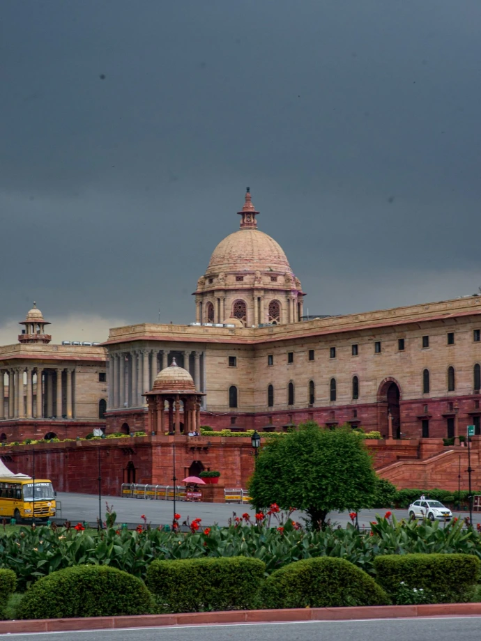 Grand building with dome under cloudy sky